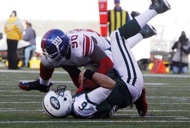 EAST RUTHERFORD, NJ - DECEMBER 24:  Mark Sanchez #6 of the New York Jets is sacked by Jason Pierre-Paul #90 of the New York Giants during the second quarter during a game at MetLife Stadium on December 24, 2011 in East Rutherford. New Jersey. (Photo by Rich Schultz /Getty Images)