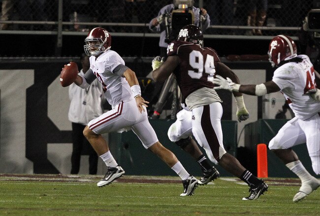 STARKVILLE, MS - NOVEMBER 12:  quarterback AJ McCarron #10 of the Alabama Crimson Tide scrambles away from pressure from defensive lineman Fletcher Cox #94 of the Mississippi State Bulldogs on November 12, 2011 at Davis Wade Stadium in Starkville, Mississippi. Alabama won 24-7. (Photo by Butch Dill/Getty Images)