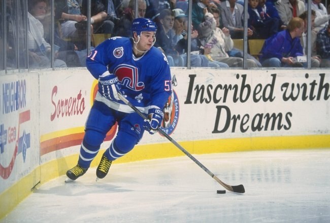 25 Nov 1992:  Rightwinger Andrei Kovalenko of the Quebec Nordiques moves the puck during a game against the Buffalo Sabres at Memorial Auditorium in Buffalo, New York. Mandatory Credit: Rick Stewart  /Allsport