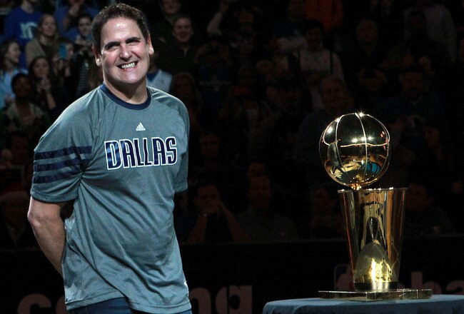 DALLAS, TX - DECEMBER 25:  Owner Mark Cuban of the Dallas Mavericks stands with the NBA trophy before a game against the Miami Heat on opening day of the NBA season at American Airlines Center on December 25, 2011 in Dallas, Texas.  NOTE TO USER: User expressly acknowledges and agrees that, by downloading and/or using this Photograph, user is consenting to the terms and conditions of the Getty Images License Agreement.  (Photo by Ronald Martinez/Getty Images)