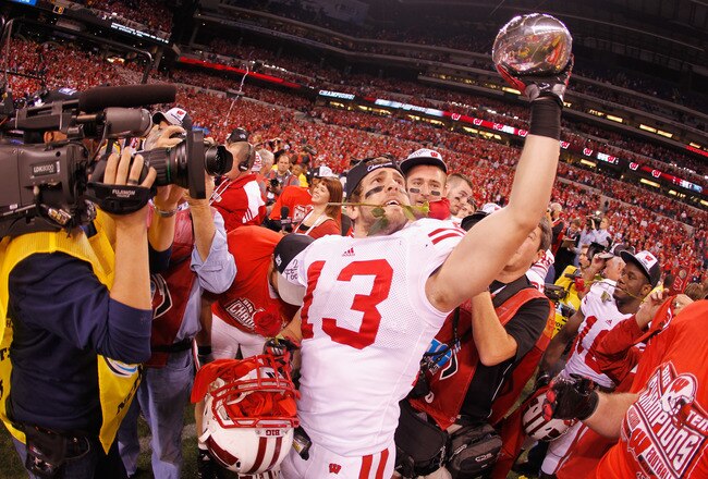 INDIANAPOLIS, IN - DECEMBER 03:  Conor O'Neill #13 of the Wisconsin Badgers celebrates with the trophy after they won 42-39 against the Michigan State Spartans\ during the Big 10 Conference Championship Game at Lucas Oil Stadium on December 3, 2011 in Indianapolis, Indiana.  (Photo by Gregory Shamus/Getty Images)