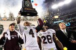 NASHVILLE, TN - DECEMBER 30:  Coach Dan Mullen, Charles Mitchell #4 and Vick Ballard #28 of the Mississippi State Bulldogs celebrate after a win over the Wake Forest Demon Deacons during at the Franklin American Mortgage Music City Bowl at LP Field on December 30, 2011 in Nashville, Tennessee. Mississippi State won 23-17.  (Photo by Grant Halverson/Getty Images)