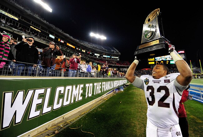 NASHVILLE, TN - DECEMBER 30:  Marcus Green #32 of the Mississippi State Bulldogs celebrates with the trophy after a win over the Wake Forest Demon Deacons during the Franklin American Mortgage Music City Bowl at LP Field on December 30, 2011 in Nashville, Tennessee. Mississippi State won 23-17.  (Photo by Grant Halverson/Getty Images)