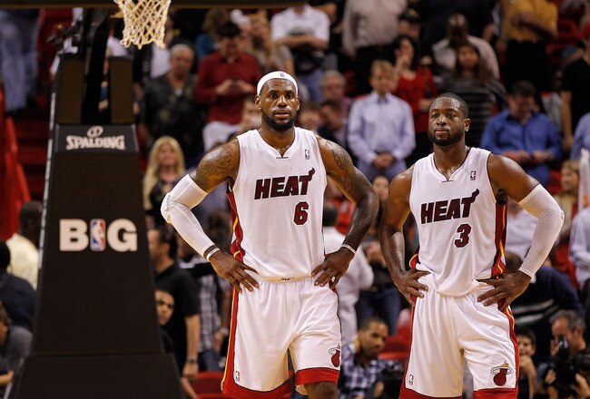 MIAMI, FL - DECEMBER 27:  LeBron James #6 and Dwyane Wade #3 of the Miami Heat look on during a game against the Boston Celtics at American Airlines Arena on December 27, 2011 in Miami, Florida. NOTE TO USER: User expressly acknowledges and agrees that, by downloading and/or using this Photograph, User is consenting to the terms and conditions of the Getty Images License Agreement.  (Photo by Mike Ehrmann/Getty Images)