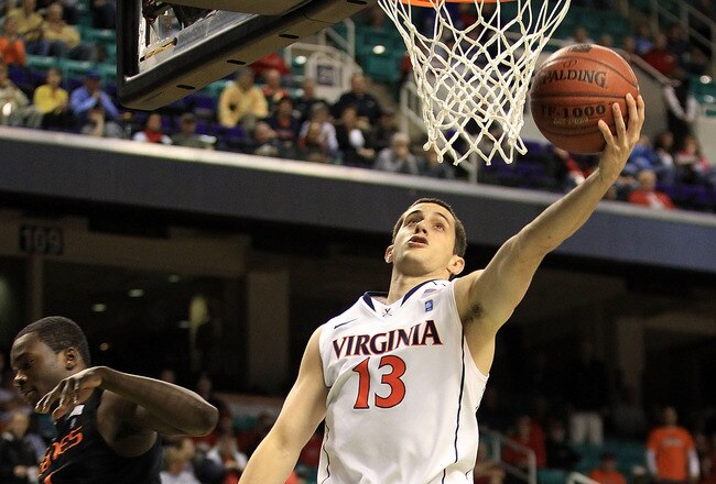 GREENSBORO, NC - MARCH 10:  Sammy Zeglinski #13 of the Virginia Cavaliers shoots against Durand Scott #1 of the Miami Hurricanes during the first half of the first round of the 2011 ACC men's basketball tournament at the Greensboro Coliseum on March 10, 2011 in Greensboro, North Carolina.  (Photo by Streeter Lecka/Getty Images)