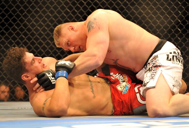 LAS VEGAS - JULY 11:  Brock Lesnar holds down Frank Mir during their heavyweight title bout during UFC 100 on July 11, 2009 in Las Vegas, Nevada.  (Photo by Jon Kopaloff/Getty Images)