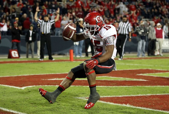 TUCSON, AZ - NOVEMBER 05:  Runningback John White IV #15 of the Utah Utes scores a 11 yard rushing touchdown against the Arizona Wildcats during the college football game at Arizona Stadium on November 5, 2011 in Tucson, Arizona.  The Utes defeated the Wildcats 34-21.  (Photo by Christian Petersen/Getty Images)