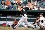 BALTIMORE, MD - AUGUST 09:  Carlos Quentin #20 of the Chicago White Sox hits a home run in the second inning against the Baltimore Orioles at Oriole Park at Camden Yards on August 9, 2011 in Baltimore, Maryland.  (Photo by Greg Fiume/Getty Images)