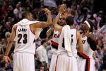 PORTLAND, OR - APRIL 21:  LaMarcus Aldridge #12, Gerald Wallace #3, Nicolas Batum #88 and Marcus Camby #23 of the Portland Trail Blazers celebrates their 97-92 victory over the Dallas Mavericks in Game Three of the Western Conference Quarterfinals in the 2011 NBA Playoffs on April 21, 2011 at the Rose Garden in Portland, Oregon. NOTE TO USER: User expressly acknowledges and agrees that, by downloading and or using this photograph, User is consenting to the terms and conditions of the Getty Images License Agreement.  (Photo by Jonathan Ferrey/Getty Images)