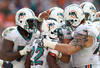 MIAMI GARDENS, FL - DECEMBER 04:  Running back Reggie Bush #22 (C) of the Miami Dolphins celebrates a touchdown with teamates against the Oakland Raiders at Sun Life Stadium on December 4, 2011 in Miami Gardens, Florida.  (Photo by Marc Serota/Getty Images)