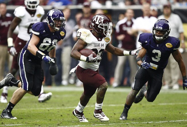 HOUSTON - DECEMBER 31:  Running back Ben Malena #23 of Texas A&M Aggies runs past Quentin Williams #88 and Jeravin Matthews #3 of the Northwestern Wildcats for a touchdown at Reliant Stadium on December 31, 2011 in Houston, Texas.  (Photo by Bob Levey/Getty Images)