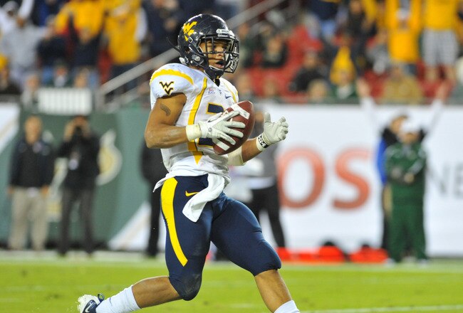 TAMPA, FL - DECEMBER 1:  Running back Dustin Garrison #29 of the West Virginia Mountaineers rushes for a game-tying touchdown in the fourth quarter against the South Florida Bulls December 1, 2011 at Raymond James Stadium in Tampa, Florida.  West Virginia won 30 - 27. (Photo by Al Messerschmidt/Getty Images)