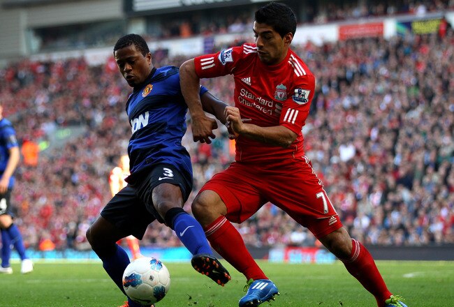 LIVERPOOL, ENGLAND - OCTOBER 15:  Luis Suarez of Liverpool tussles for posesssion with Patrice Evra of Manchester United during the Barclays Premier League match between Liverpool and Manchester United at Anfield on October 15, 2011 in Liverpool, England.  (Photo by Clive Brunskill/Getty Images)