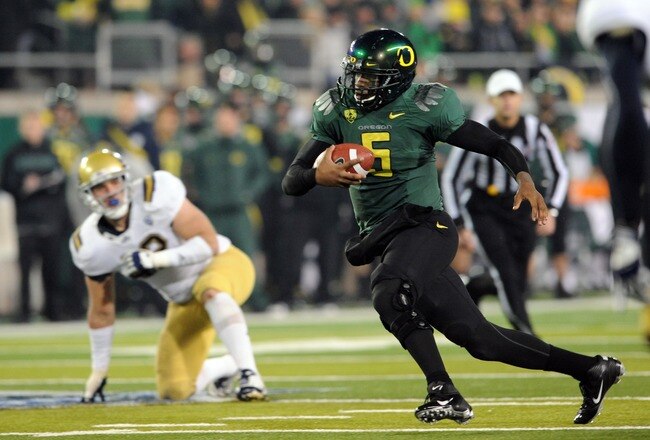 EUGENE, OR - DECEMBER 02 : Quarterback Darron Thomas #5 of the Oregon Ducks breaks out into the open during the third quarter of the Pac-12 Championship against the UCLA Bruins at Autzen Stadium on December 2, 2011 in Eugene, Oregon. The Ducks won the game 49-31 to earn a berth in the Rose Bowl. (Photo by Steve Dykes/Getty Images)