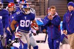 EAST RUTHERFORD, NJ - JANUARY 01:  Victor Cruz #80 of the New York Giants runs with the ball on his way to scoring a touchdown in the first quarter on a 74 yard catch and run against the Dallas Cowboys as head coach Tom Coughlin looks on from the sidelines at MetLife Stadium on January 1, 2012 in East Rutherford, New Jersey.  (Photo by Al Bello/Getty Images)