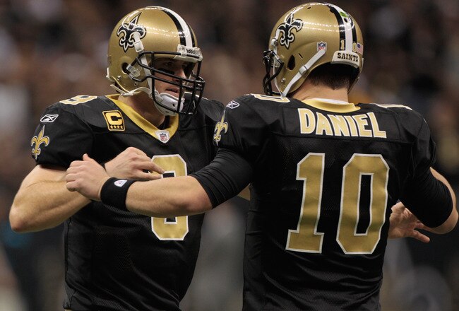 NEW ORLEANS, LA - JANUARY 01:  Drew Brees #9 celebrates after a touchdown with  Chase Daniel #10 of the New Orleans Saints during the game against the Carolina Panthers at the Mercedes-Benz Superdome on January 1, 2012 in New Orleans, Louisiana.  (Photo by Chris Graythen/Getty Images)