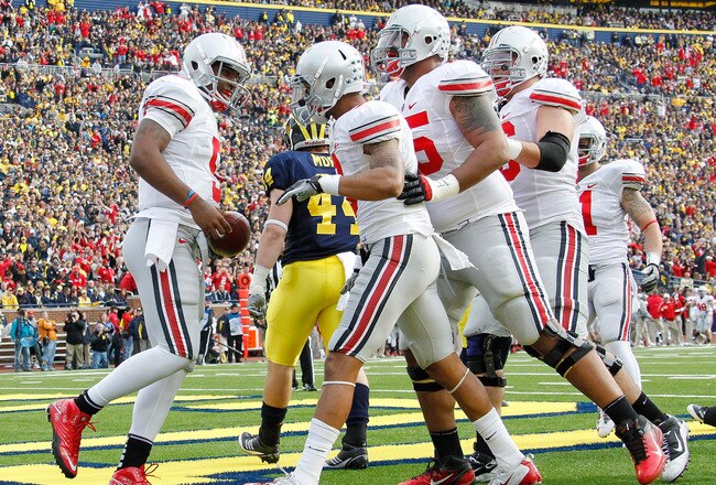 ANN ARBOR, MI - NOVEMBER 26:  Braxton Miller #5 of the Ohio State Buckeyes celebrates a second quarter touchdown with teammates while playing the Michigan Wolverines at Michigan Stadium on November 26, 2011 in Ann Arbor, Michigan. (Photo by Gregory Shamus/Getty Images)
