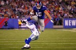 EAST RUTHERFORD, NJ - JANUARY 01:   Henry Hynoski #45 of the New York Giants leaps over  Terence Newman #41 of the Dallas Cowboys at MetLife Stadium on January 1, 2012 in East Rutherford, New Jersey.  (Photo by Al Bello/Getty Images)