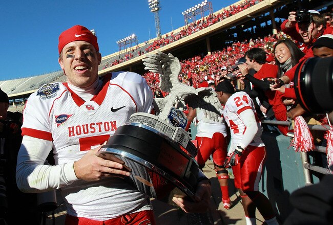 DALLAS, TX - JANUARY 02:  Case Keenum #7 of the Houston Cougars carries the TicketCity Bowl trophy after a 30-14 win against the Penn State Nittany Lions at Cotton Bowl Stadium on January 2, 2012 in Dallas, Texas.  (Photo by Ronald Martinez/Getty Images)