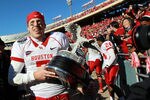 DALLAS, TX - JANUARY 02:  Case Keenum #7 of the Houston Cougars carries the TicketCity Bowl trophy after a 30-14 win against the Penn State Nittany Lions at Cotton Bowl Stadium on January 2, 2012 in Dallas, Texas.  (Photo by Ronald Martinez/Getty Images)