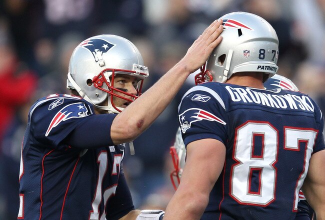 FOXBORO, MA - JANUARY 1:    Tom Brady #12 of the New England Patriots celebrates with teammate  Rob Gronkowski #87 of the New England Patriots after a touchdown against the Buffalo Bills in the second half at Gillette Stadium on January 1, 2012 in Foxboro, Massachusetts. (Photo by Jim Rogash/Getty Images)