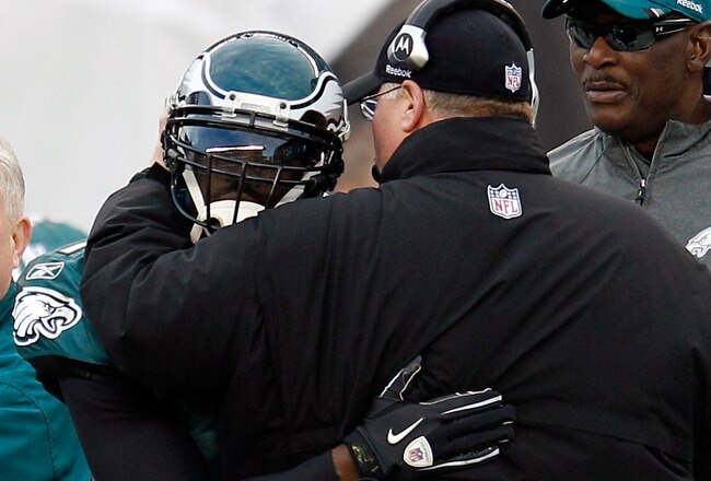 PHILADELPHIA, PA - JANUARY 01:  Michael Vick #7 of the Philadelphia Eagles hugs head coach Andy Reid after Vick threw a touchdown pass against the Washington Redskins during the second half at Lincoln Financial Field on January 1, 2012 in Philadelphia, Pennsylvania.  (Photo by Rob Carr/Getty Images)