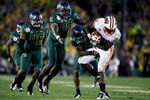 PASADENA, CA - JANUARY 02:  Running back Montee Ball #28 of the Wisconsin Badgers runs the ball as he is hit by Troy Hill #2 of the Oregon Ducks in the second half at the 98th Rose Bowl Game on January 2, 2012 in Pasadena, California.  (Photo by Jeff Gross/Getty Images)