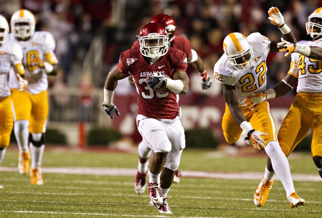 FAYETTEVILLE, AR - NOVEMBER 12:   Dennis Johnson #33 of the Arkansas Razorbacks runs the ball for a touchdown against the Tennessee Volunteers on his back at Donald W. Reynolds Stadium Stadium on November 12, 2011 in Fayetteville, Arkansas.  (Photo by Wesley Hitt/Getty Images)