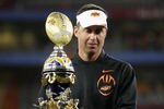 GLENDALE, AZ - JANUARY 02:  Head coach Mike Gundy of the Oklahoma State Cowboys celebrates with the trophy after the Oklahoma State Cowboys won 41-38 in overtime against the Stanford Cardinal during the Tostitos Fiesta Bowl on January 2, 2012 at University of Phoenix Stadium in Glendale, Arizona.  (Photo by Donald Miralle/Getty Images)