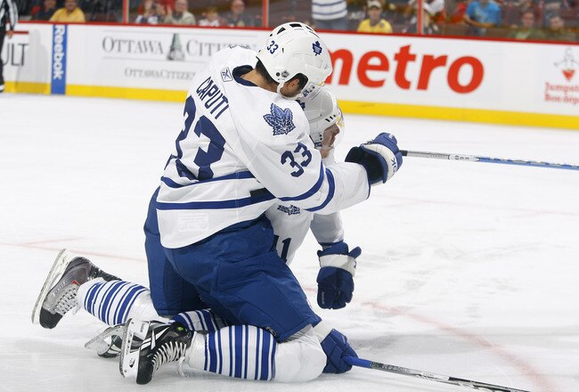 KANATA, ON - SEPTEMBER 29: Nikolai Kulemin #41 of the Toronto Maple Leafs is mobbed by teammate Luca Caputi #33 after scoring a goal against the Ottawa Senators during a game at Scotiabank Place on September 29, 2010 in Kanata, Canada.  (Photo by Phillip MacCallum/Getty Images)