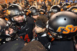 GLENDALE, AZ - JANUARY 02:  The Oklahoma State Cowboys celebrate around Colton Chelf #83 (C) after believing he scored the game winning touchdown in overtime against the Stanford Cardinal during the Tostitos Fiesta Bowl at the Universtity of Phoenix Stadium on January 2, 2012 in Glendale, Arizona. Chelf was downed on the one yard line and play resumed. The Cowboys defeated the Cardinal 41-38 in overtime. (Photo by Christian Petersen/Getty Images)