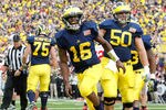 ANN ARBOR, MI - NOVEMBER 26: Denard Robinson #16 of the Michigan Wolverines celebrates a second quarter touchdown with David Molk #50 while playing the Ohio State Buckeyes at Michigan Stadium on November 26, 2011 in Ann Arbor, Michigan. (Photo by Gregory Shamus/Getty Images)