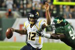 TAMPA, FL - DECEMBER 1:  Quarterback Geno Smith #12 of the West Virginia Mountaineers rushes upfield against the South Florida Bulls December 1, 2011 at Raymond James Stadium in Tampa, Florida.  West Virginia won 30 - 27. (Photo by Al Messerschmidt/Getty Images)