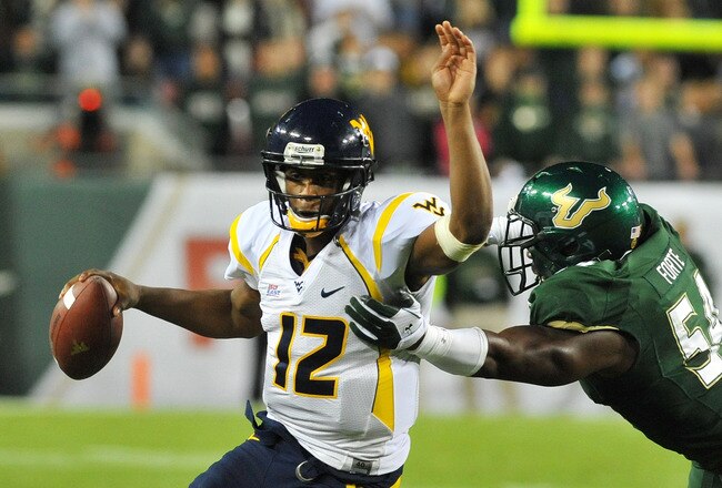 TAMPA, FL - DECEMBER 1:  Quarterback Geno Smith #12 of the West Virginia Mountaineers rushes upfield against the South Florida Bulls December 1, 2011 at Raymond James Stadium in Tampa, Florida.  West Virginia won 30 - 27. (Photo by Al Messerschmidt/Getty Images)