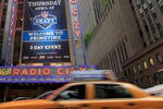 NEW YORK, NY - APRIL 28:  Taxi cabs drive down the Avenue of the Americas past the Radio City Music Hall marquee, site of the 2011 NFL Draft, on April 28, 2011 in New York City.  (Photo by Chris Trotman/Getty Images)