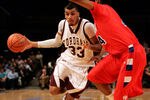 NEW YORK - JANUARY 13:  Chris Gaston #33 of the Fordham Rams handles the ball against Josh Benson #44 of the Dayton Flyers at Madison Square Garden on January 13, 2010 in New York, New York.  (Photo by Mike Lawrie/Getty Images)