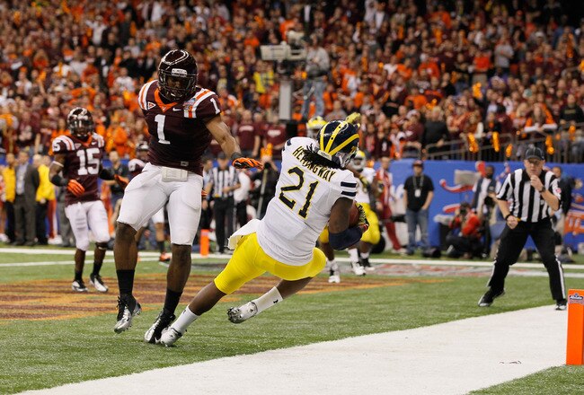 NEW ORLEANS, LA - JANUARY 03:  Junior Hemingway #21 of the Michigan Wolverinescores a 18-yard touchdown reception in the third quarter against Antone Exum #1 of the Virginia Tech Hokies during the Allstate Sugar Bowl at Mercedes-Benz Superdome on January 3, 2012 in New Orleans, Louisiana.  (Photo by Kevin C. Cox/Getty Images)