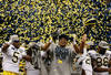 NEW ORLEANS, LA - JANUARY 03:  The Michigan Wolverines celebrate as confetti falls after they won 23-20 against the Virginia Tech Hokies during the Allstate Sugar Bowl at Mercedes-Benz Superdome on January 3, 2012 in New Orleans, Louisiana.  (Photo by Chris Graythen/Getty Images)