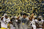 NEW ORLEANS, LA - JANUARY 03:  The Michigan Wolverines celebrate as confetti falls after they won 23-20 against the Virginia Tech Hokies during the Allstate Sugar Bowl at Mercedes-Benz Superdome on January 3, 2012 in New Orleans, Louisiana.  (Photo by Chris Graythen/Getty Images)