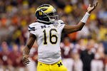NEW ORLEANS, LA - JANUARY 03:  Denard Robinson #16 of the Michigan Wolverines celebrates after he threw an 18-yard touchdown pass to Junior Hemingway #21 in the third quarter against the Virginia Tech Hokies during the Allstate Sugar Bowl at Mercedes-Benz Superdome on January 3, 2012 in New Orleans, Louisiana.  (Photo by Kevin C. Cox/Getty Images)
