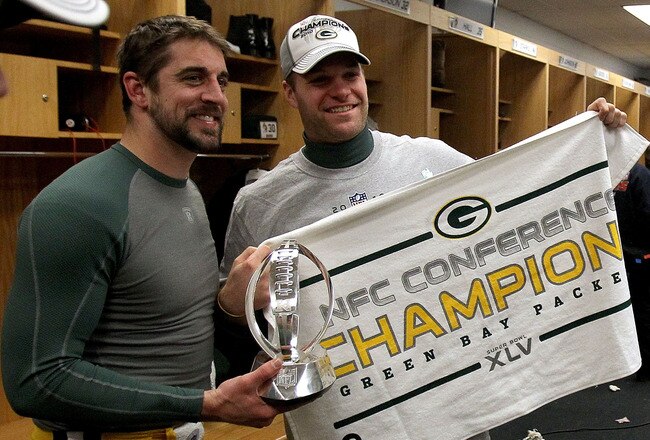 CHICAGO, IL - JANUARY 23:  (L-R) Quarterback Aaron Rodgers #12 and Matt Flynn #10 of the Green Bay Packers celebrate the Packers 21-14 victory against the Chicago Bears with the George Halas Trophy after the NFC Championship Game at Soldier Field on January 23, 2011 in Chicago, Illinois.  (Photo by Jonathan Daniel/Getty Images)
