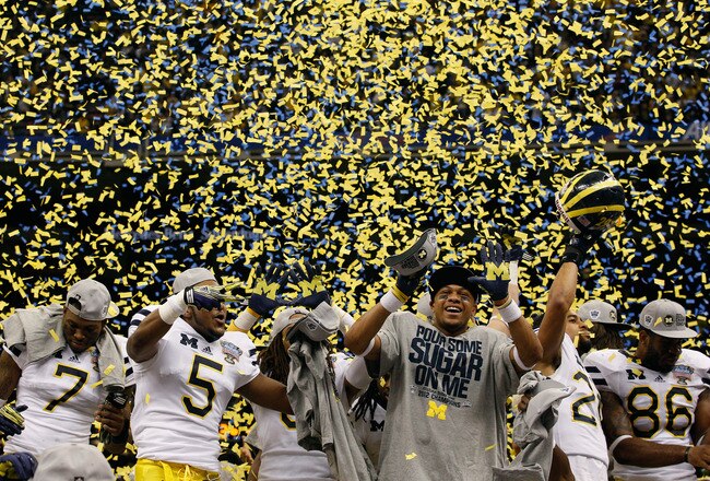 NEW ORLEANS, LA - JANUARY 03:  The Michigan Wolverines celebrate as confetti falls after they won 23-20 against the Virginia Tech Hokies during the Allstate Sugar Bowl at Mercedes-Benz Superdome on January 3, 2012 in New Orleans, Louisiana.  (Photo by Chris Graythen/Getty Images)