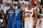ATLANTA, GA - APRIL 22:  Al Horford #15 of the Atlanta Hawks reacts after their 88-84 win over Dwight Howard #12, Brandon Bass #30 and the Orlando Magic during Game Three of the Eastern Conference Quarterfinals in the 2011 NBA Playoffs at Philips Arena on April 22, 2011 in Atlanta, Georgia.  (Photo by Kevin C. Cox/Getty Images)