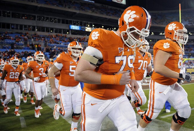 CHARLOTTE, NC - DECEMBER 03:  The Clemson Tigers take the field for warm ups led by Phillip Price #79 prior to the ACC Championship game against the Virginia Tech Hokies at Bank of America Stadium on December 3, 2011 in Charlotte, North Carolina.  (Photo by Jared C. Tilton/Getty Images)