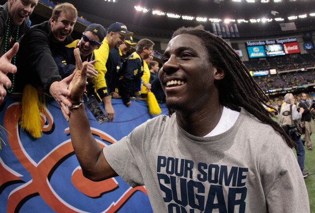 NEW ORLEANS, LA - JANUARY 03:  Denard Robinson #16 of the Michigan Wolverines celebrates as he runs off of the field after Michigan won 23-20 in overtime against Virginia Tech Hokies during the Allstate Sugar Bowl at Mercedes-Benz Superdome on January 3, 2012 in New Orleans, Louisiana.  (Photo by Chris Graythen/Getty Images)
