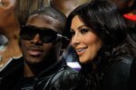 NEW ORLEANS - JANUARY 18:  New Orleans Saints player Reggie Bush sits with Kim Kardashian on the court during the game between the San Antonio Spurs and the New Orleans Hornets at New Orleans Arena on January 18, 2010 in New Orleans, Louisiana.   NOTE TO USER: User expressly acknowledges and agrees that, by downloading and/or using this Photograph, User is consenting to the terms and conditions of the Getty Images License Agreement.  (Photo by Chris Graythen/Getty Images)