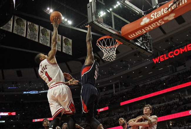 CHICAGO, IL - JANUARY 03:  Derrick Rose #1 of the Chicago Bulls goes up for a shot on his way to a game-high 30 points against Josh Smith #5 of the Atlanta Hawks at the United Center on January 3, 2012 in Chicago, Illinois. The Bulls defeated the Hawks 76-74. NOTE TO USER: User expressly acknowledges and agrees that, by downloading and or using this photograph, User is consenting to the terms and conditions of the Getty Images License Agreement.  (Photo by Jonathan Daniel/Getty Images)