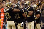 NEW ORLEANS, LA - JANUARY 01:  Junior Galette #93 celebrates with Patrick Robinson #21 of the New Orleans Saints after catching an interception during the game against the Carolina Panthers at the Mercedes-Benz Superdome on January 1, 2012 in New Orleans, Louisiana.  (Photo by Chris Graythen/Getty Images)