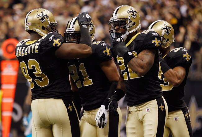 NEW ORLEANS, LA - JANUARY 01:  Junior Galette #93 celebrates with Patrick Robinson #21 of the New Orleans Saints after catching an interception during the game against the Carolina Panthers at the Mercedes-Benz Superdome on January 1, 2012 in New Orleans, Louisiana.  (Photo by Chris Graythen/Getty Images)