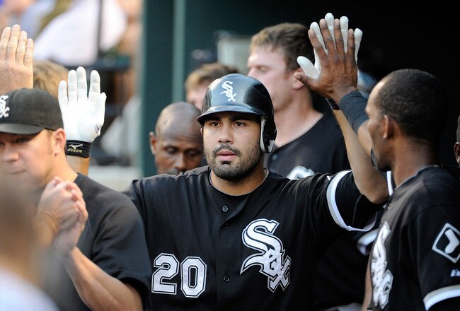BALTIMORE, MD - AUGUST 09:  Carlos Quentin #20 of the Chicago White Sox celebrates with teammates after hitting a home run in the second inning against the Baltimore Orioles at Oriole Park at Camden Yards on August 9, 2011 in Baltimore, Maryland.  (Photo by Greg Fiume/Getty Images)